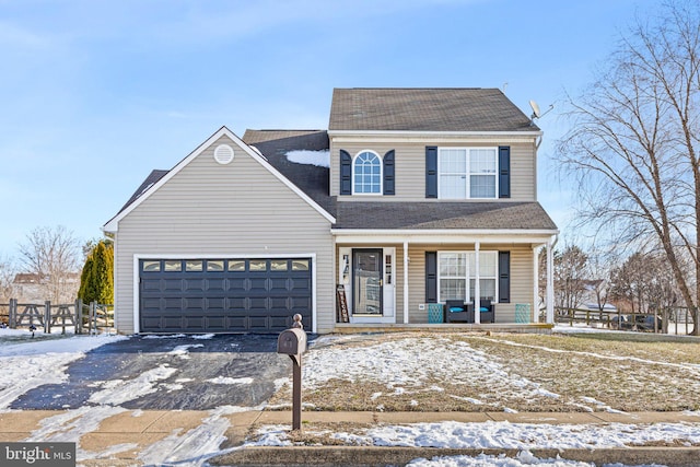 view of front property featuring a garage and covered porch