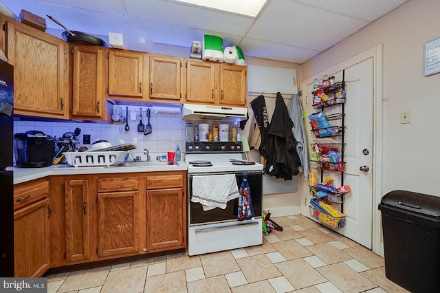 kitchen featuring a paneled ceiling, white electric range oven, sink, and backsplash