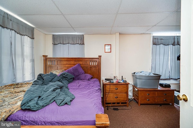 carpeted bedroom with a paneled ceiling