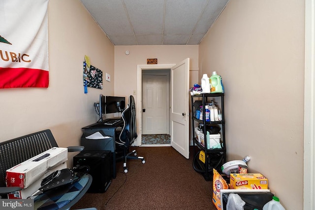 carpeted office space with a drop ceiling