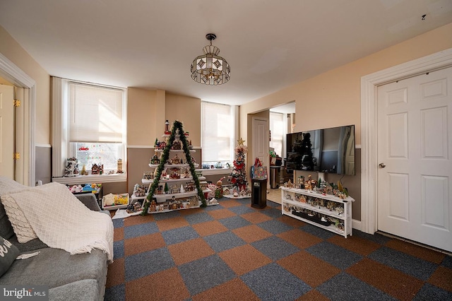 workout area with an inviting chandelier and plenty of natural light