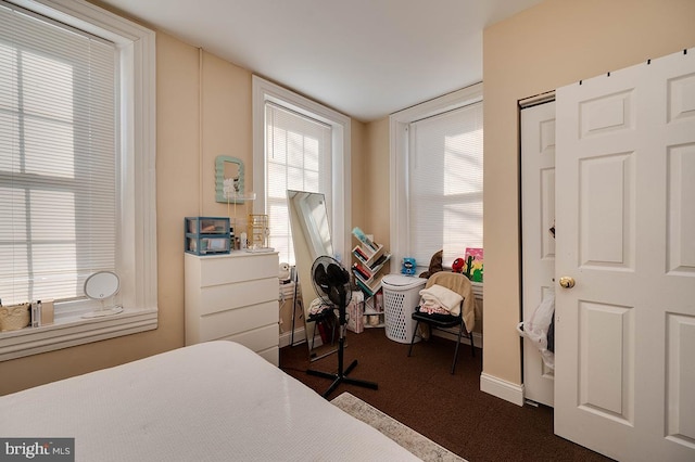 bedroom featuring dark carpet