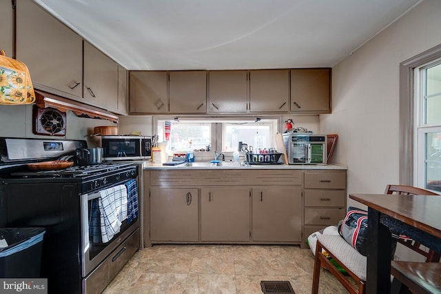 kitchen with sink and appliances with stainless steel finishes