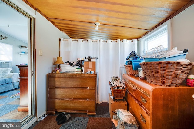 interior space with a wealth of natural light, cooling unit, wood ceiling, and dark carpet