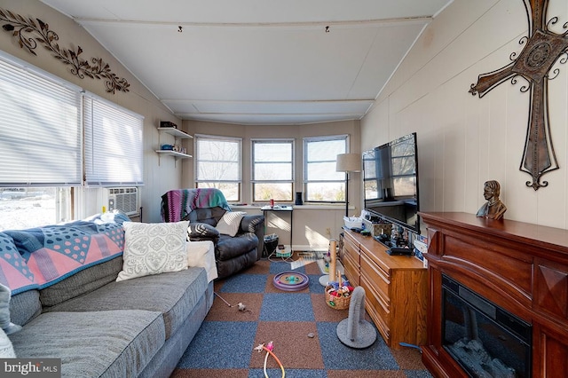 living room featuring vaulted ceiling and cooling unit