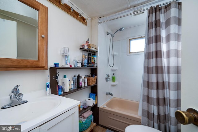 full bathroom featuring shower / bath combo, vanity, and toilet