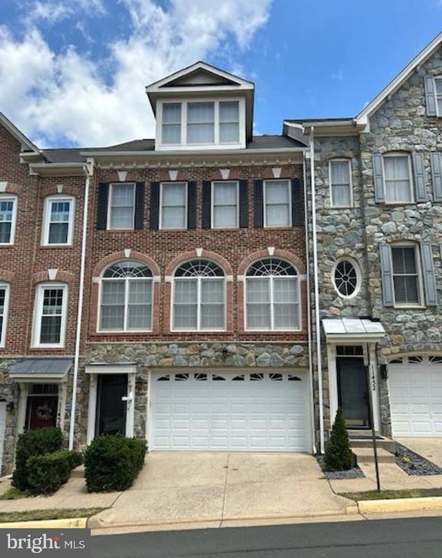 townhome / multi-family property with a garage