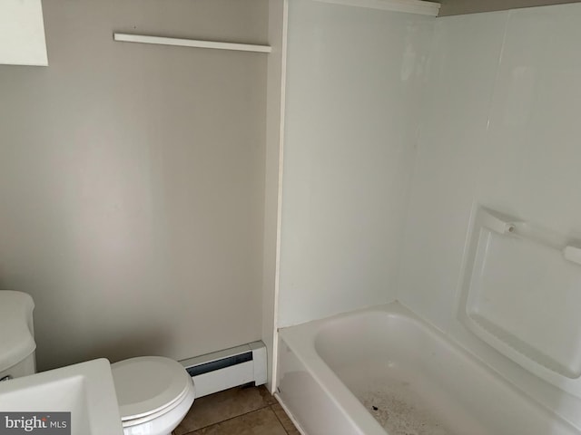 bathroom featuring a tub, toilet, tile patterned floors, and a baseboard heating unit