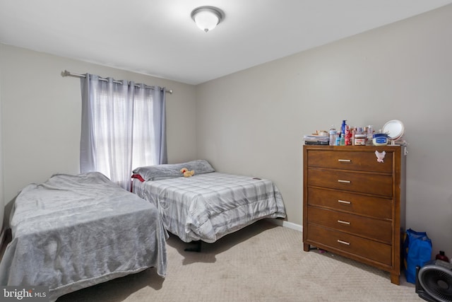 bedroom featuring light carpet