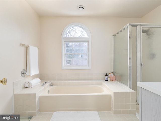 bathroom with separate shower and tub and tile patterned floors