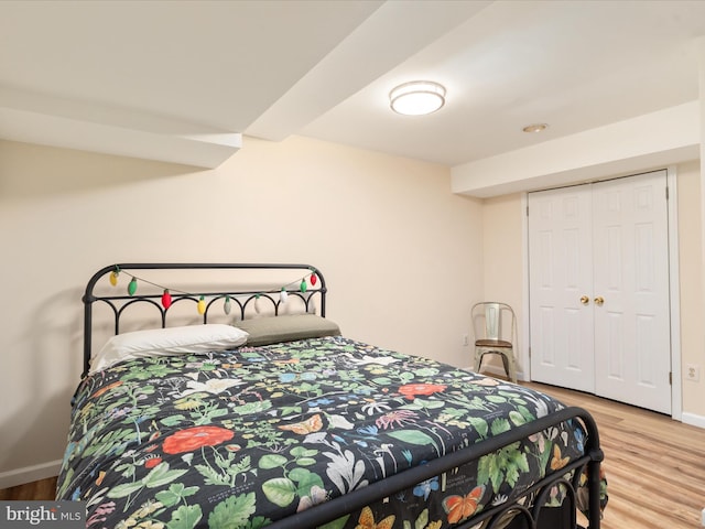 bedroom featuring light wood-type flooring and a closet