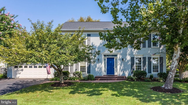 view of front of home featuring a garage and a front yard