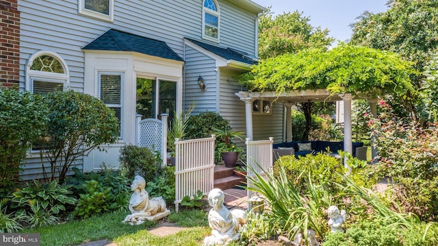 doorway to property with a pergola