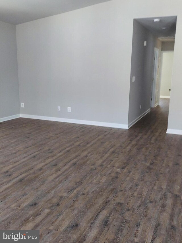 empty room with dark hardwood / wood-style floors