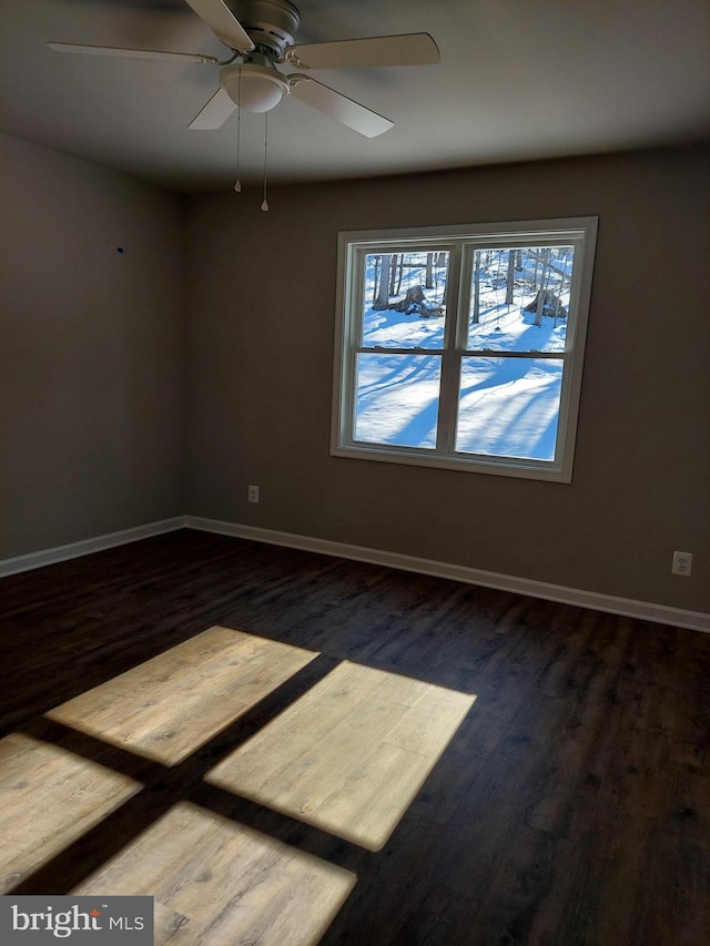 unfurnished room with ceiling fan and dark hardwood / wood-style flooring