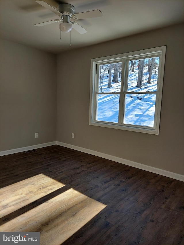 unfurnished room with dark hardwood / wood-style flooring and ceiling fan