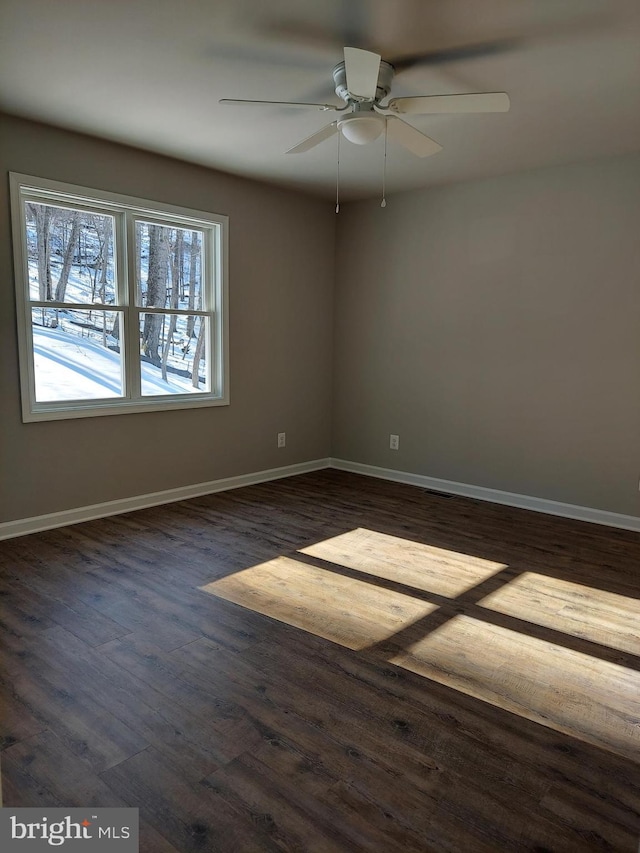 unfurnished room with ceiling fan and dark hardwood / wood-style flooring