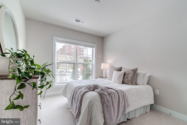 bedroom with light colored carpet