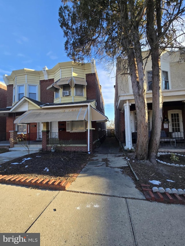 townhome / multi-family property with a porch