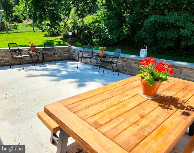 wooden terrace featuring a yard and a patio