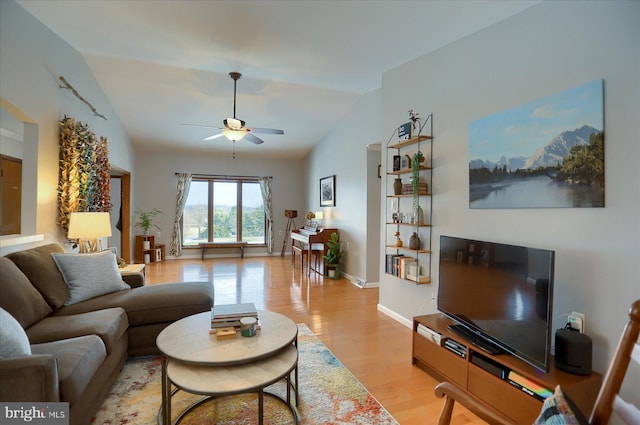 living room with vaulted ceiling, ceiling fan, and light hardwood / wood-style flooring