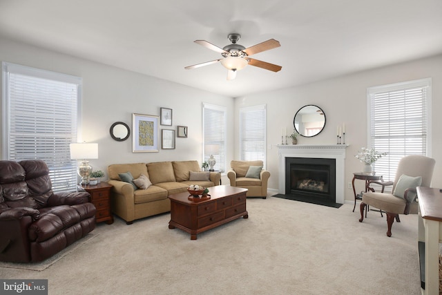 carpeted living room featuring ceiling fan