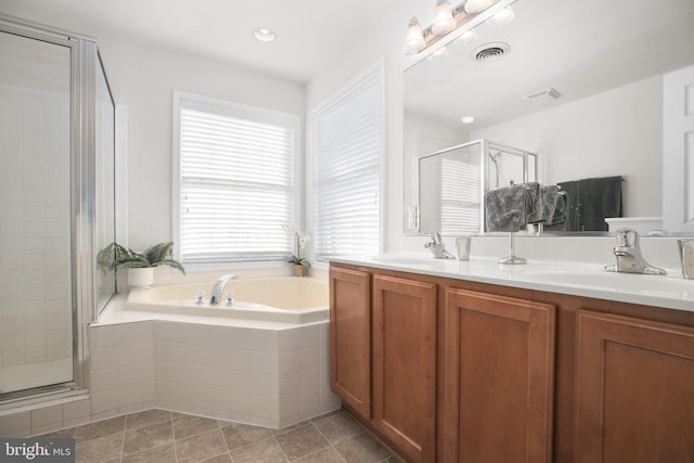 bathroom with tile patterned floors, independent shower and bath, and vanity