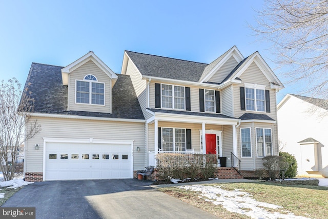 view of front facade with a garage and covered porch