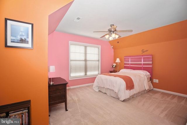 bedroom with vaulted ceiling, light colored carpet, and ceiling fan