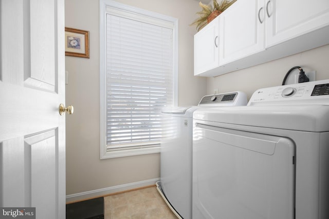 laundry room with cabinets and washing machine and clothes dryer