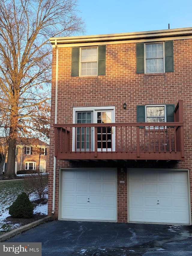 back of property with a garage