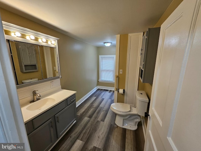 bathroom with decorative backsplash, vanity, wood-type flooring, and toilet