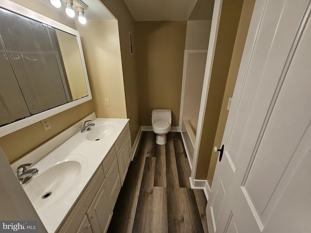 bathroom with vanity, wood-type flooring, and toilet