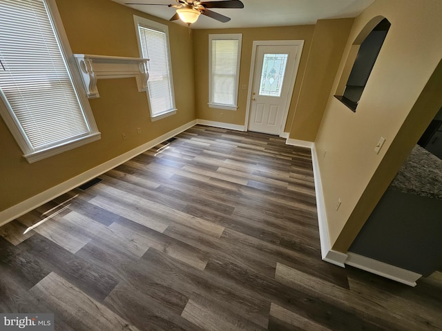 entryway with ceiling fan and dark wood-type flooring