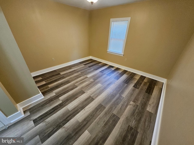 spare room with dark hardwood / wood-style flooring