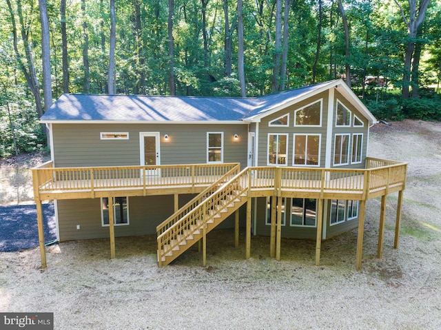 back of property with stairway and a wooden deck