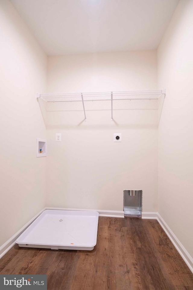 laundry area with dark hardwood / wood-style flooring, hookup for a washing machine, and hookup for an electric dryer