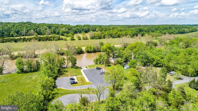 aerial view featuring a water view and a wooded view