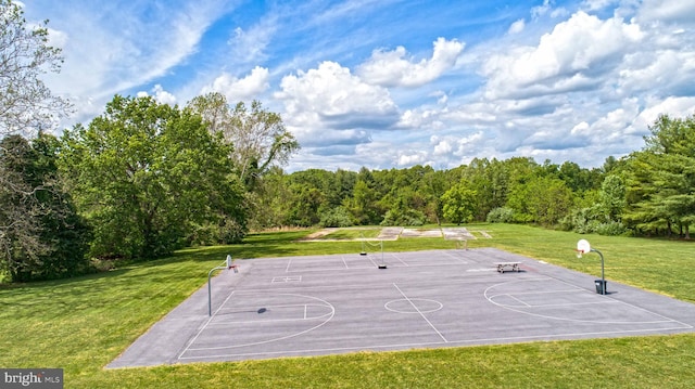 view of basketball court featuring a yard