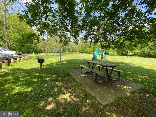 view of community with a lawn and a playground