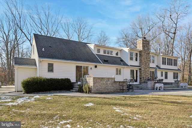 back of house with a yard and a patio area