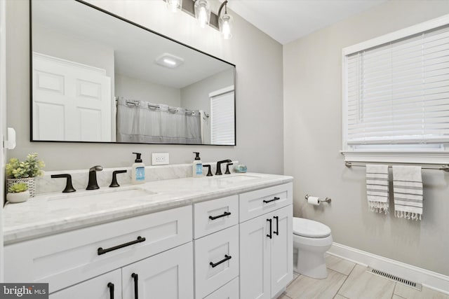 bathroom featuring toilet, tile patterned flooring, a shower with shower curtain, and vanity