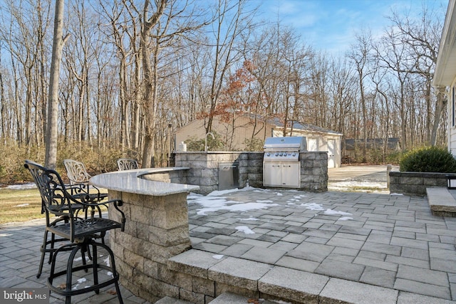 view of patio / terrace featuring grilling area, exterior bar, and area for grilling