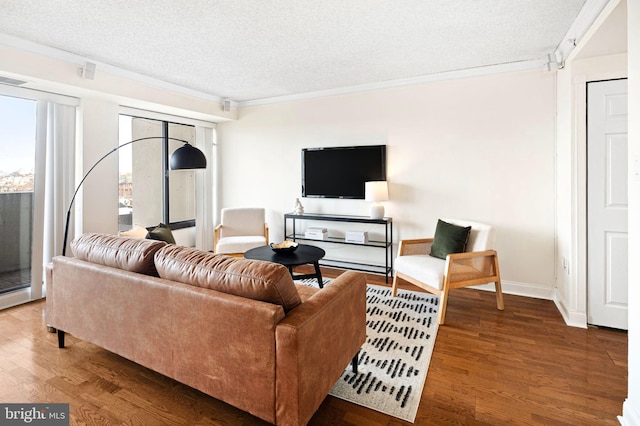 living room featuring crown molding, hardwood / wood-style floors, and a textured ceiling