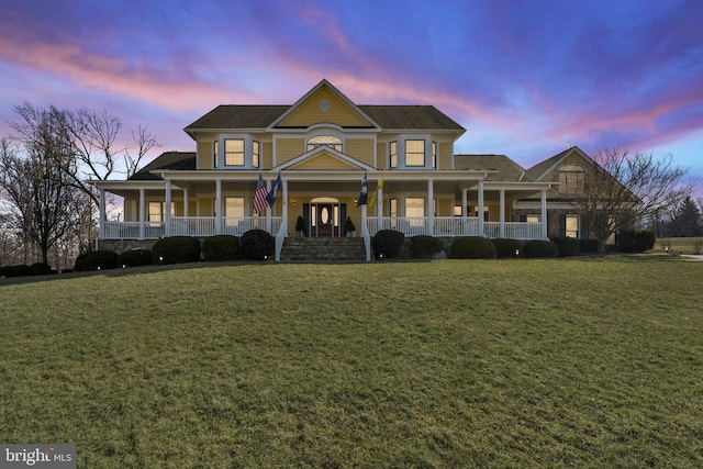 view of front of house with a yard and covered porch