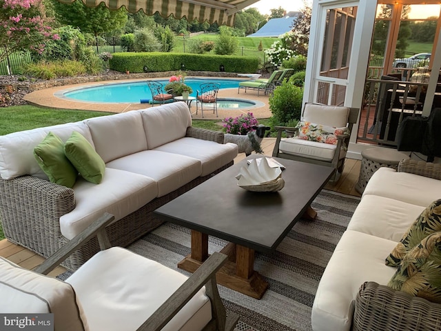 view of patio with fence, an outdoor pool, and an outdoor hangout area