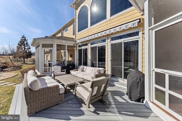 deck featuring area for grilling, an outdoor hangout area, and a sunroom