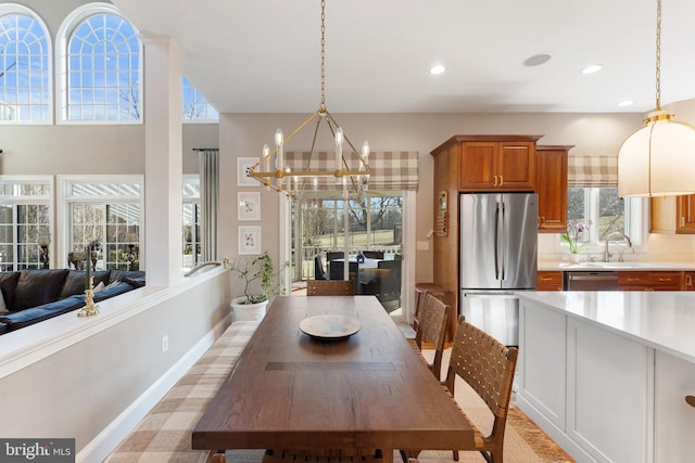 dining space with a notable chandelier, recessed lighting, and baseboards