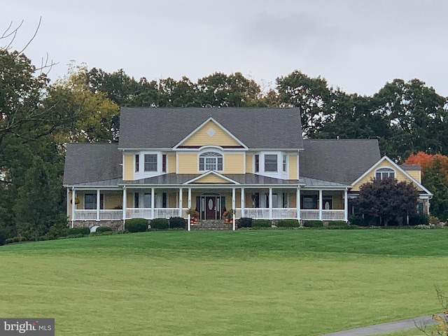 view of front of home featuring covered porch and a front lawn