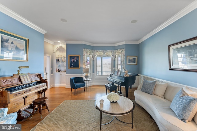 living area with wood finished floors and ornamental molding